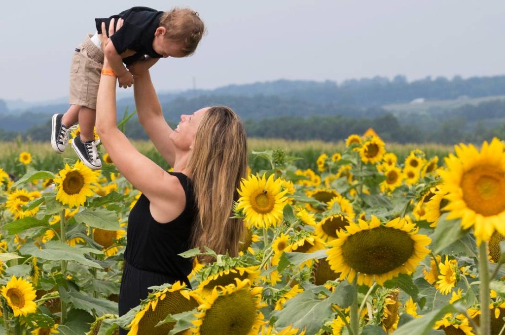 Mother and son in a sunflower field on a Tennessee farm